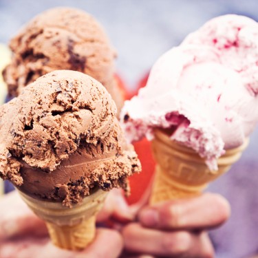Girl holding three ice cream cones with chocolate and strawberry creams.
GettyImages-114630929.jpg
