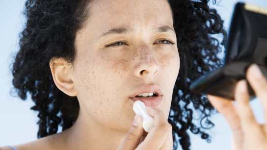 Woman applying lip balm