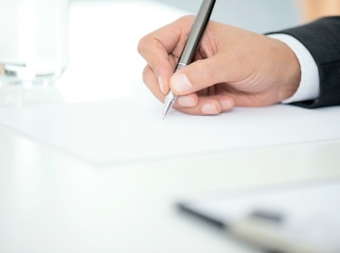   Man Signing Contract Paper