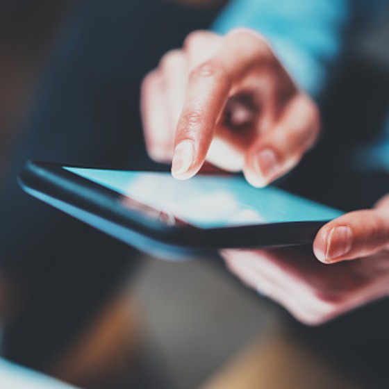 Closeup view of woman holding modern smartphone