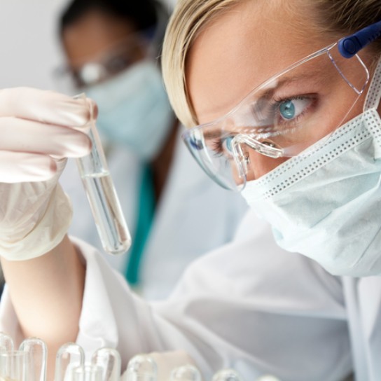 Female Scientific Research Team With Clear Solution In Laboratory
