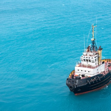 Tugboat in tropical blue ocean water