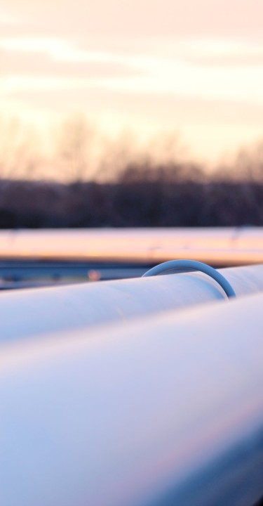 steel long pipe system in crude oil factory during sunset