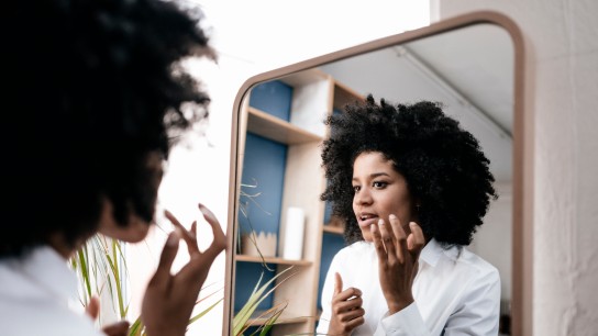 Young woman applying lip care