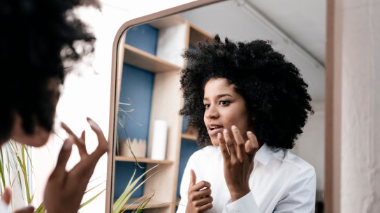 Young woman applying lip care
