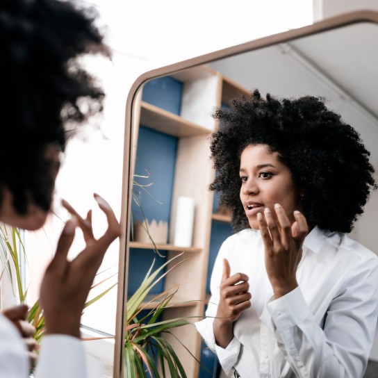 Young woman applying lip care