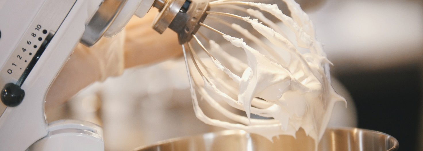 Process of cooking meringue whipped egg whites on mixer whisk , close up
GettyImages-876000170.jpg