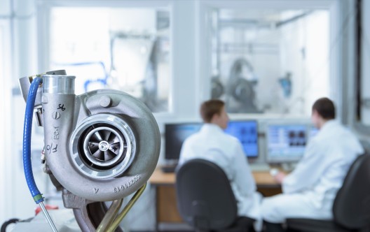 Scientists working at computers in turbo charger