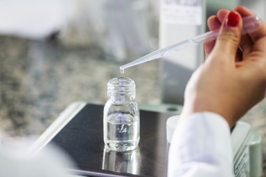 Serious chemist analyzing chemical in test tube