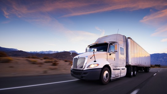 Truck and highway at sunset