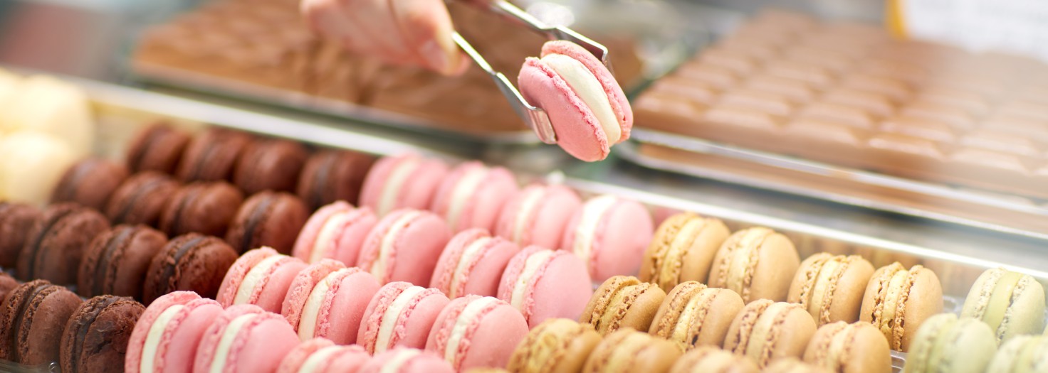 Sellers hand taking out macaron from glass case
GettyImages-587773392.jpg