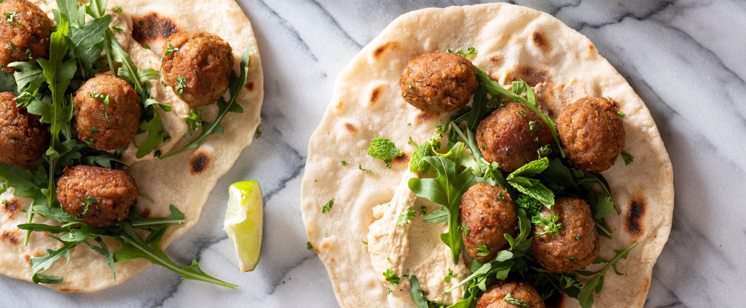 Soya and plant based meatballs, vegan certified. Homemade flatsbreads, made with flour, water, salt and olive oil. Home made hummus. Herbs to garnish. Olive oil used in cooking.
GettyImages-1208984527.jpg