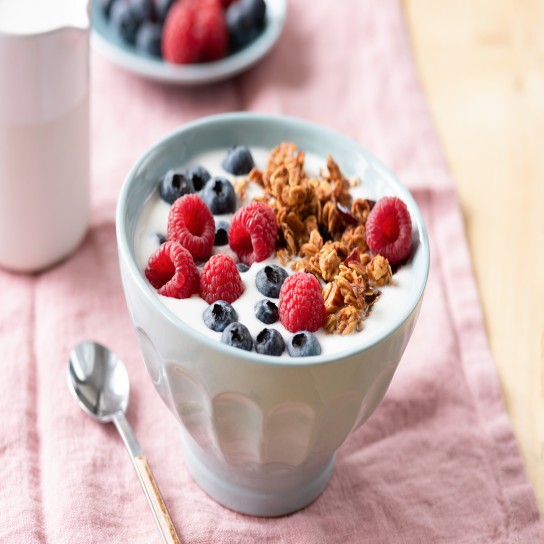 Yogurt with granola and berries in bowl on pink textile. Concept of healthy eating, dieting, weight loss
GettyImages-1077059538.jpg