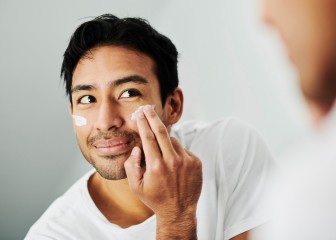 Young male applying face cream during his morning skincare routine. Portrait of an attractive healthy man using skin beauty products. Head of a happy guy pampering himself with a facial treatment.
GettyImages-1412486187.jpg