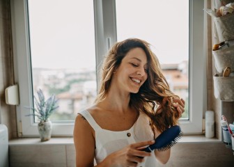 Young woman combing hair
GettyImages-1251345644.jpg